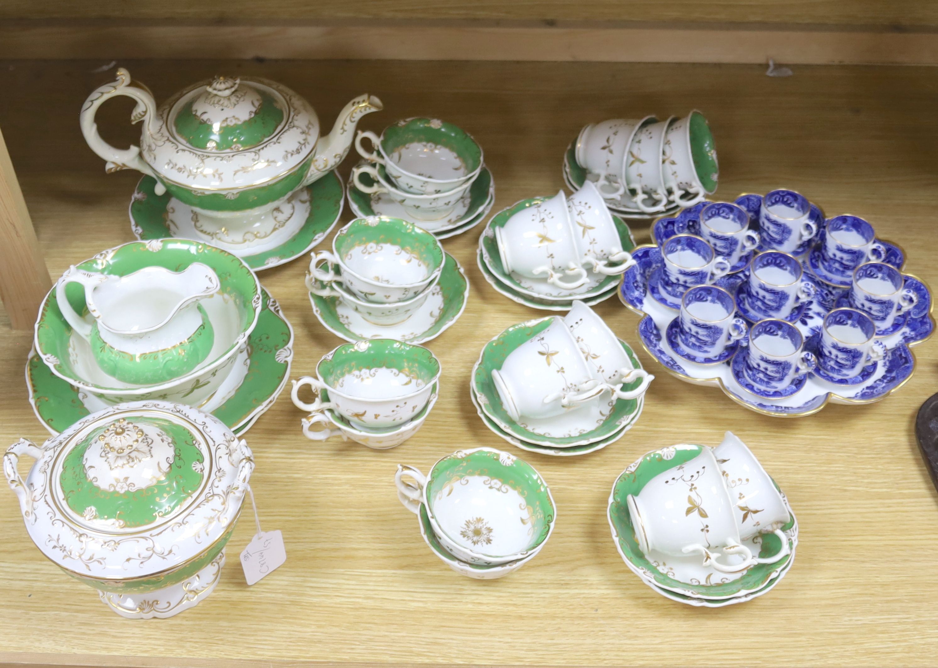 A Copeland blue and white nine cup and saucer cabaret set on stand and a 19th century Rockingham style green and gilt decorated tea ser